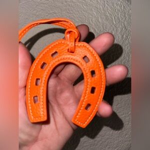 Celebrity look horseshoe purse charms in faux leather orange with white thread